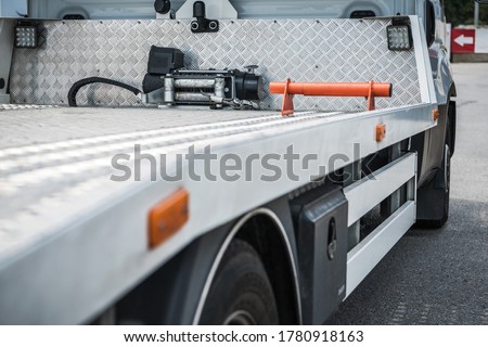Side Rear of Empty Modern Mid Size Towing Truck Close Up. Automotive Transportation.
