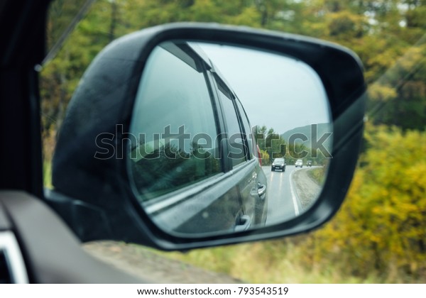 side
rear-view mirror, autumn road at the car side
mirror