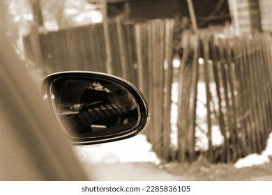 side rear-view mirror on a modern car in the street