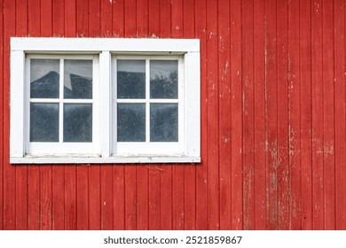 side of a red barn and window