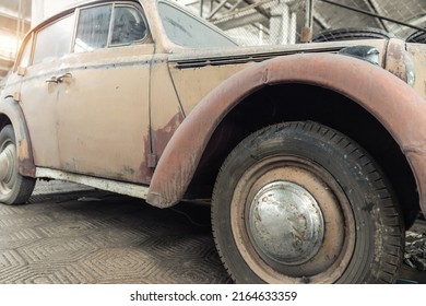 Side Rusty Abandoned Forgotten Antique Oldtimer Old Car And Motorcycles At Junkyard Factory Storage Warehouse Indoors. Classic Vintage Retro Vehicles Detail Garage Workshop Restore Renovation Station.