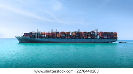 Side Ship view of Cargo Container Ship with Tug boat carrying container and running very fast for export cargo from container yard port to custom ,Contrail line in the ocean
