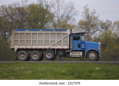 Side Shot Of Dumptruck On The Highway