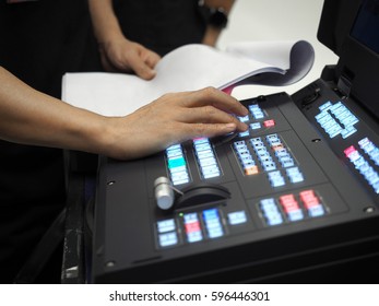 Side shot of unidentified user using media switcher to edit and broadcast video