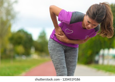 Side Stitch - Woman Runner Side Cramps After Running.