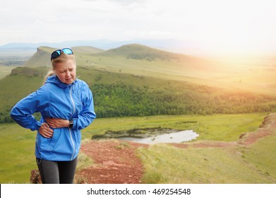 Side Stitch - Woman Runner Side Cramps. Running In The Mountains