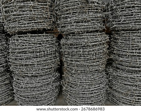 Side texture of stacked barbed wire rolls.