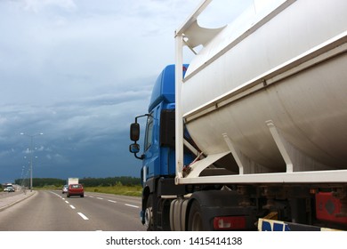 Side Of The Truck Carrying Portable Fuel Tank On The Road With Stormy Weather