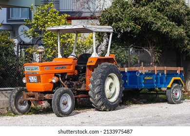 Side; Turkey – February 18 2022 : Old orange Tractor of brand Turk Fiat 640  is parked  on the street on a warm  day 