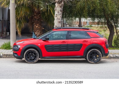 Side, Turkey – February 20 2022:  Red Citroën C4 Cactus  Is Parking  On The Street On A  Summer Day Against The Backdrop Of A Park