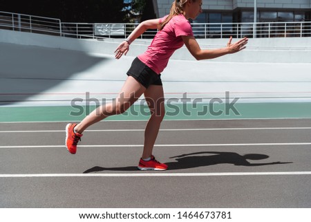 side view action of a woman sprinter on running track  