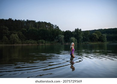 Side View Of Active Senior Woman Swimmer Diving Outdoors In Lake.