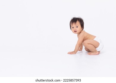 Side View Of Adorable Asian Baby In Diaper Sitting And Crawling Isolated White Background. Happy Little Baby Boy Smile Playing And Enjoy. Healthy And Strong Baby Learning To Crawing And Walking.