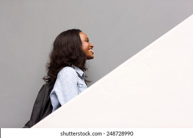 Side View Of African American College Student Walking Up The Stairs