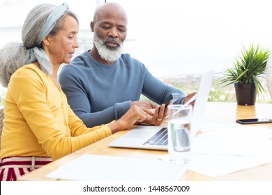 Side View Of African American Couple Calculating Finances. Authentic Senior Retired Life Concept