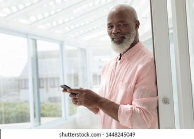 Side view of African American Man using smartphone. Authentic Senior Retired Life Concept