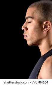 Side View Of African American Man Standing With Closed Eyes Isolated On Black