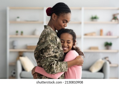 Side View Of African American Woman In Military Uniform Mother Hugging Her Child Happy Curly Girl Teenager At Home, Mom Came Back From Military Service, Embracing With Her Daughter, Copy Space