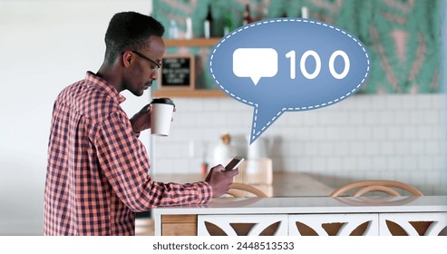 Side view of an African-american man leaning on a kitchen counter sipping on a cup of coffee while texting. Beside him is a digital image of a message bubble with a message icon increasing in count - Powered by Shutterstock - Get 15% off with code: PIKWIZARD15