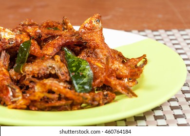 Side View Of Anchovies Fish Fry In A Plate . This Fish Is Also Know As Netholi, Nethili & Kozhuva In South India Which Is Spicy Seafood.