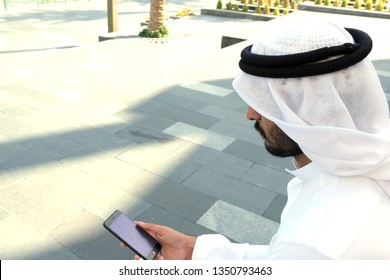 Side View Of Arab Man Using Smart Mobile Phone Device