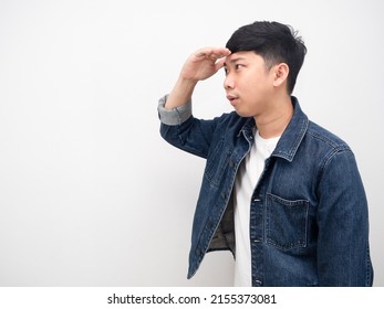 Side View Asian Man Jean Shirt Gesture Hand Over Head For Looking