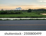 Side view of asphalt road with landscape of sunset sky.