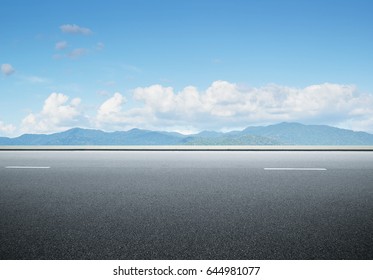 Side view asphalt road on sunny summer day near the mountain . - Shutterstock ID 644981077