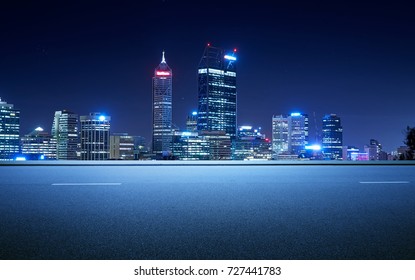 Side View Asphalt Road On Night Scene Near The Modern City .