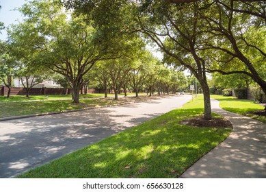 Side View Of Asphalt Road, Street In Suburban Residential Area With Lot Of Green Trees In Katy, Texas, US. America Is An Excellent Green And Clean Country. Environmental And Transportation Background.