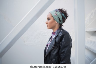 Side View Of Attractive Woman With Hairband Sitting On Stairs