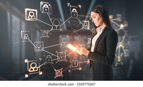 Side view of attractive young european businesswoman using tablet with glowing business interface on blurry office interior background. Social network and technology concept. Double exposure 