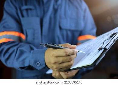 Side View, An Auditor Or Specter Holding A Clipboard And Checklist Of Assessments And Inspections On A Black Background And Light Bokeh.