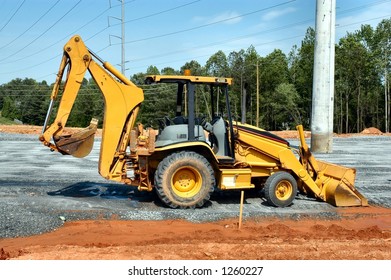 Side view of a backhoe loader at rest