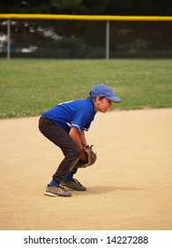 Side View Of A Baseball Player In The Infield