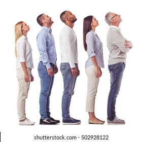 Side View Of Beautiful Business People In Smart Casual Wear Looking Upward And Smiling While Standing One By One On A White Background