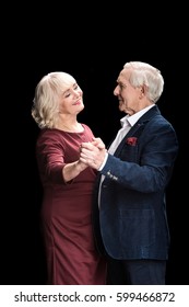 Side View Of Beautiful Happy Senior Couple Dancing Isolated On Black