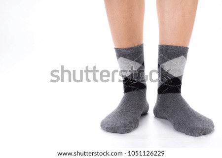 Side view of beautiful human foot dressed in new nice and soft natural cotton fabric blank sock isolated on abstract white background. Wearing and sport clothes concept. Detailed closeup studio shot.