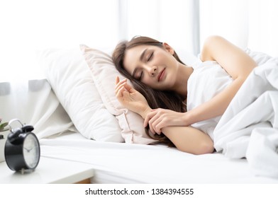 Side View Of Beautiful Young Asian Woman Smiling While Sleeping In Her Bed And Relaxing In The Morning. Lady Enjoying Sweet Dreams And Enough Rest Concept