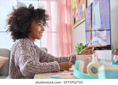 Side View Of Black African American Teen Pupil Writing Learning With Teacher Tutor Video Class On Desktop Computer At Home. Remote Distant Homeschooling Concept.