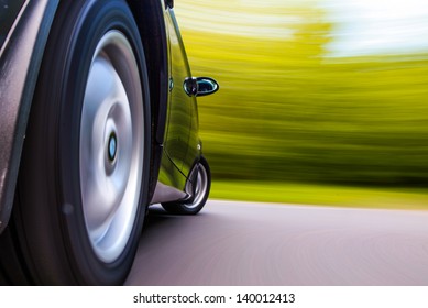 Side view of black car in turn - Shutterstock ID 140012413