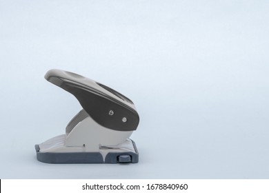 Side view of a black hole punch against a gray background