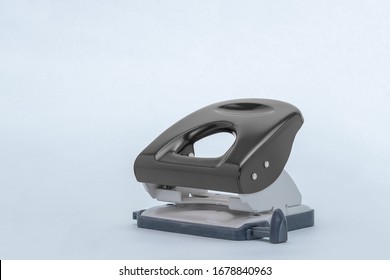 Side view of a black hole punch against a gray background