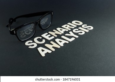 Side View Of Block Letters On Scenario Analysis With Eyeglasses On Black Background.