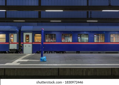 Side view of blue passenger train at empty platform railway station in Europe - Powered by Shutterstock