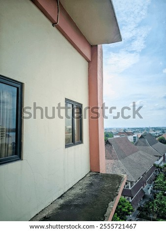 Similar – Image, Stock Photo Weathered balcony of an old rustic colonial building with laundry hanging, green shutters, railing, and visible wires overhead showing a candid scene of the khmer daily life in Kampot, Cambodia