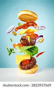 A side view of burger components in an expoded view against a blue background