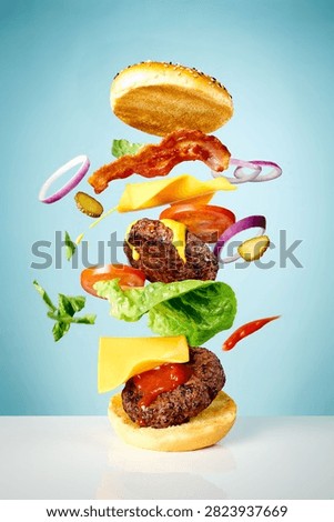 A side view of burger components in an expoded view against a blue background