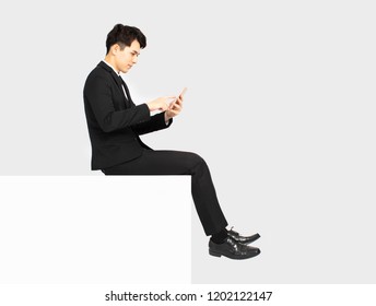 Side View Of Business Man Sitting On Blank Panel 