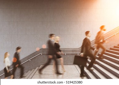 Side view of business people climbing a stair in a building on a morning. Concept of business person's routine. Toned image. Mock up